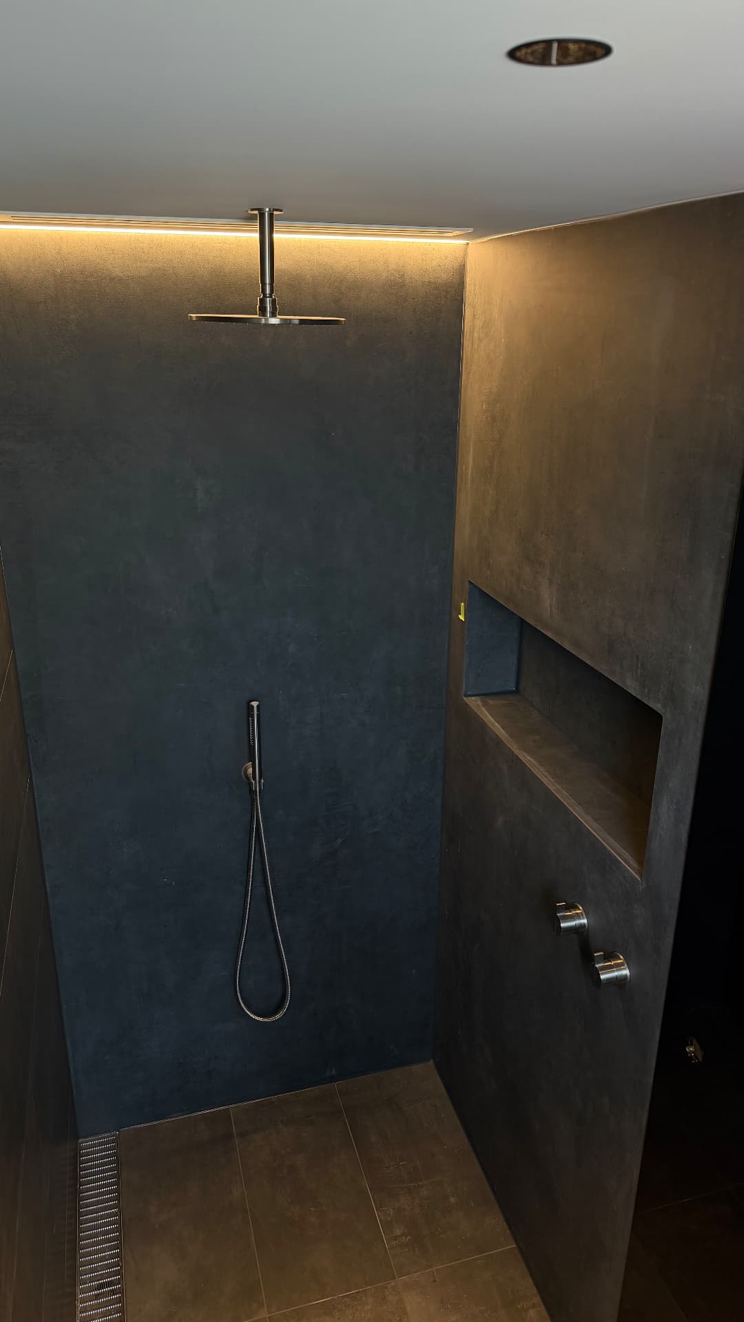Walk-in shower with sealed wall panels and niche joints