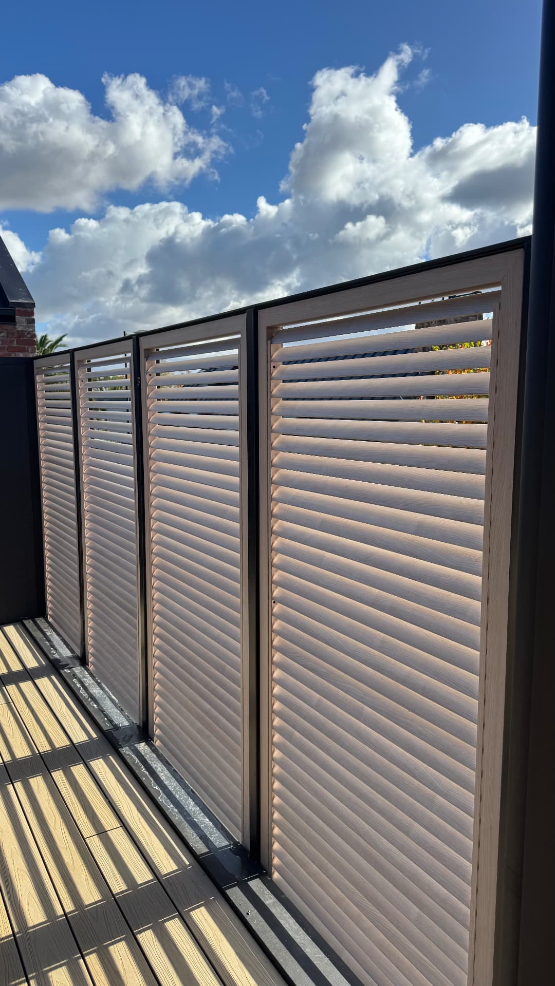 Timber louvre privacy screens sealed to a balcony deck