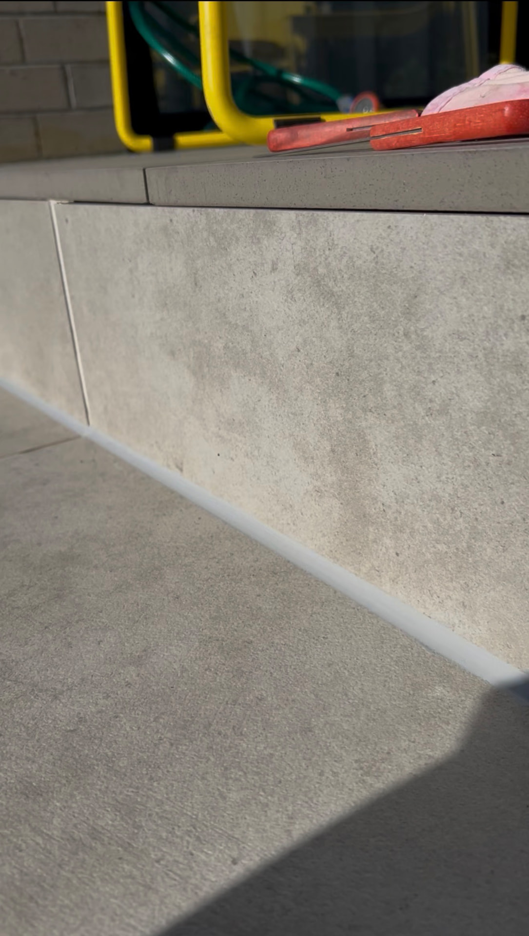 External sealed joint between tiled step and paving