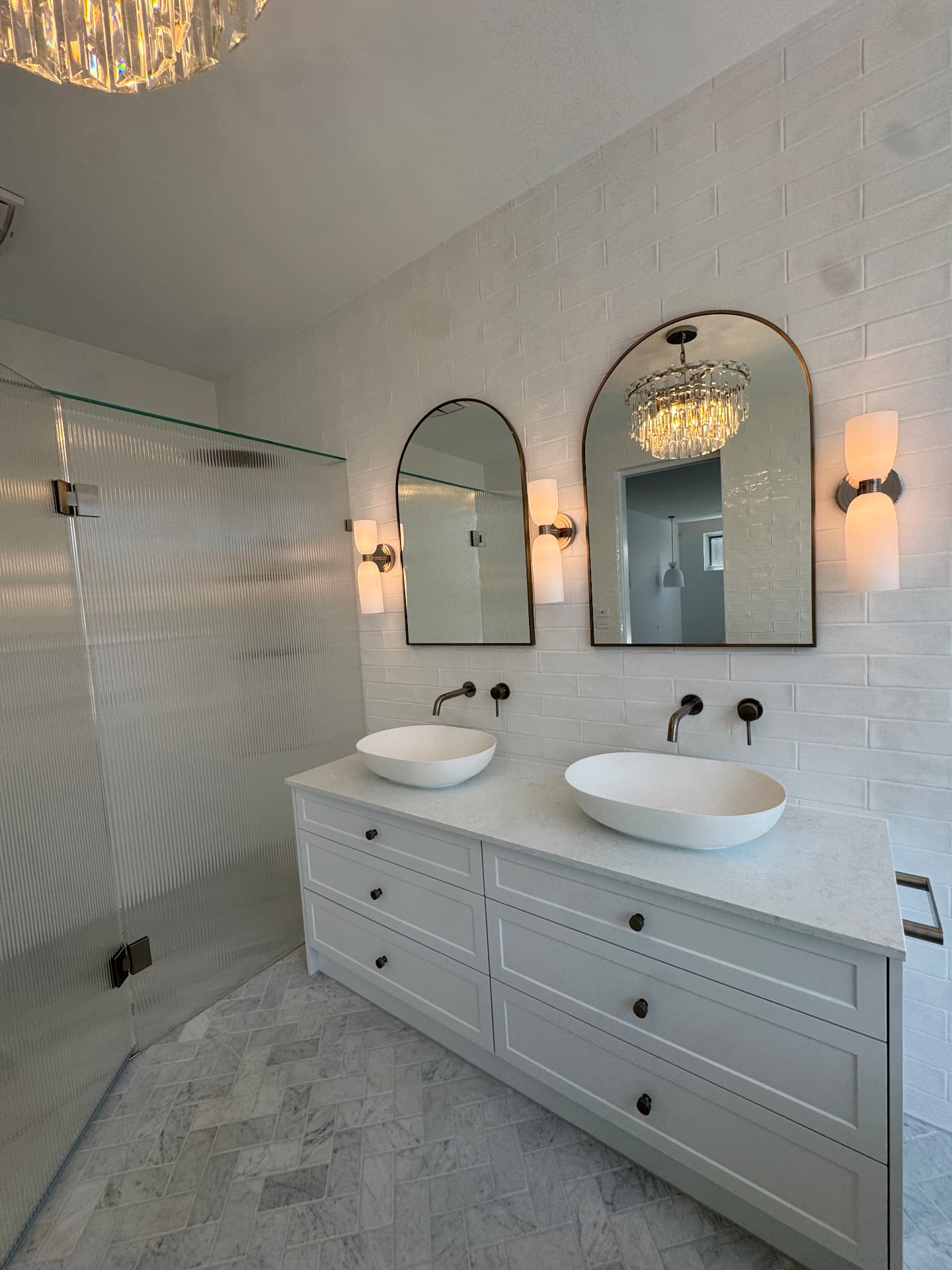 Double vessel basin vanity sealed to stone benchtop and tiled wall