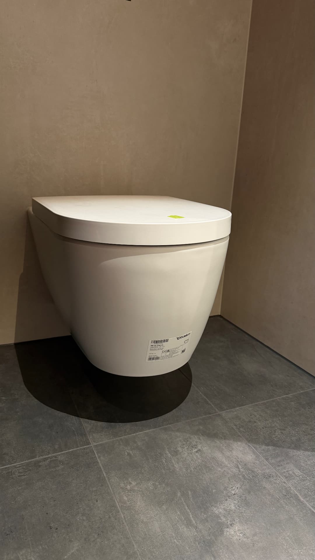 Wall-hung toilet with sealed wall and floor junctions