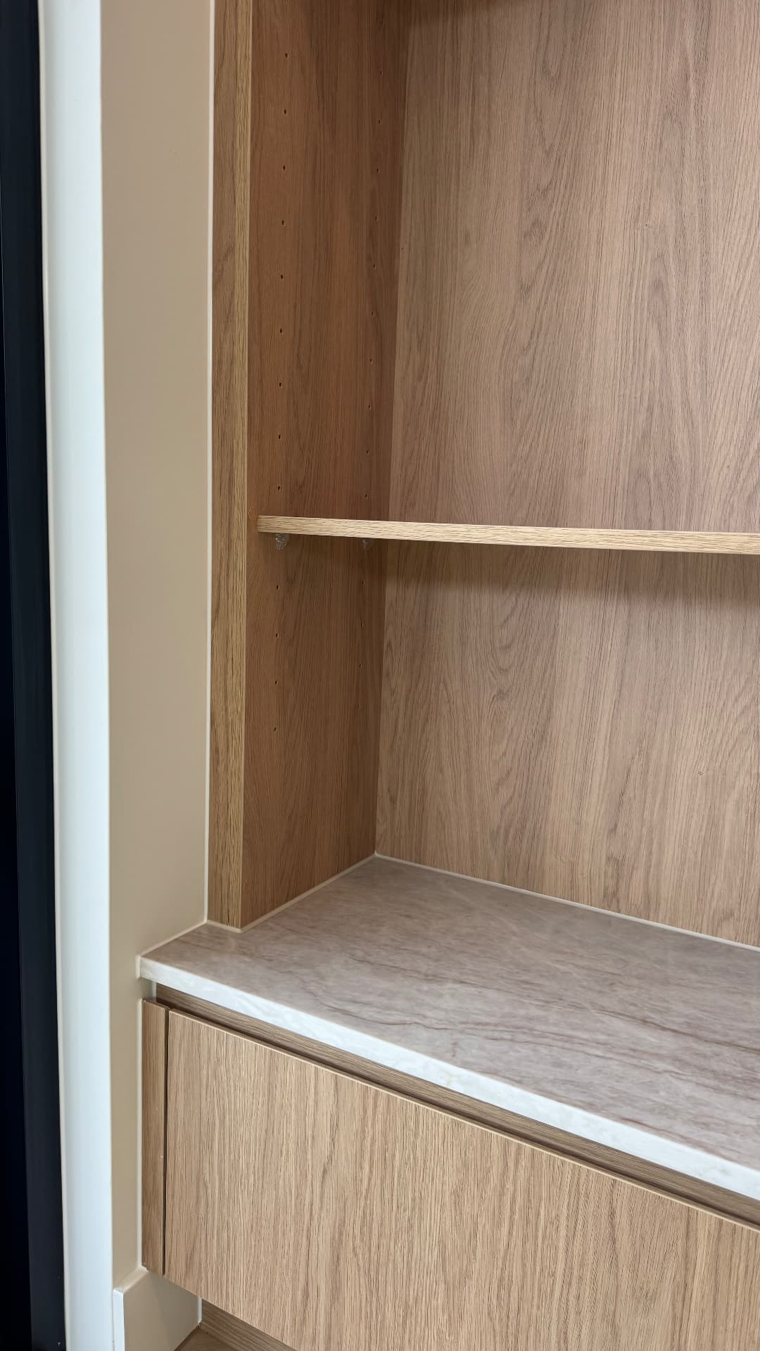 Joinery niche with sealed stone shelf and timber panel joints