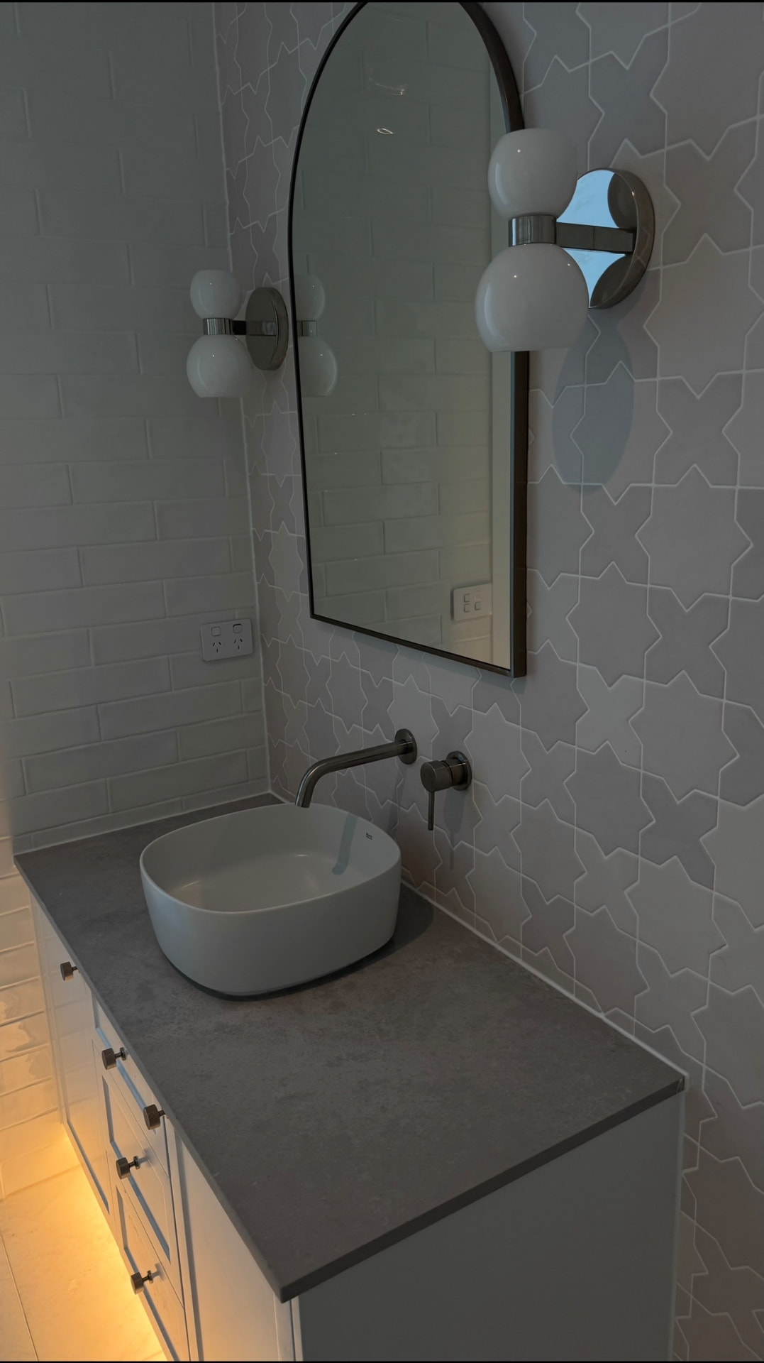 Powder room vanity with sealed stone benchtop and tiles
