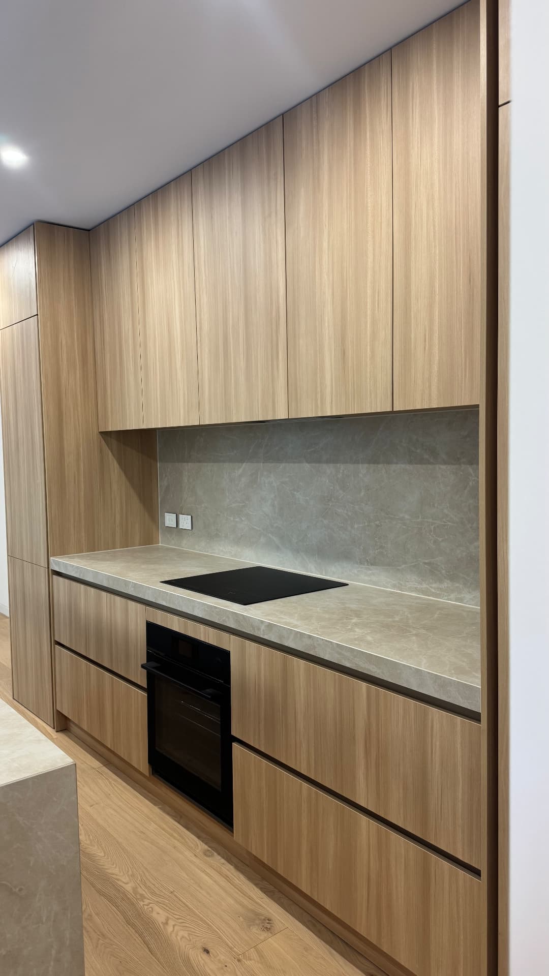 Timber kitchen with sealed splashback, benchtop and cabinetry
