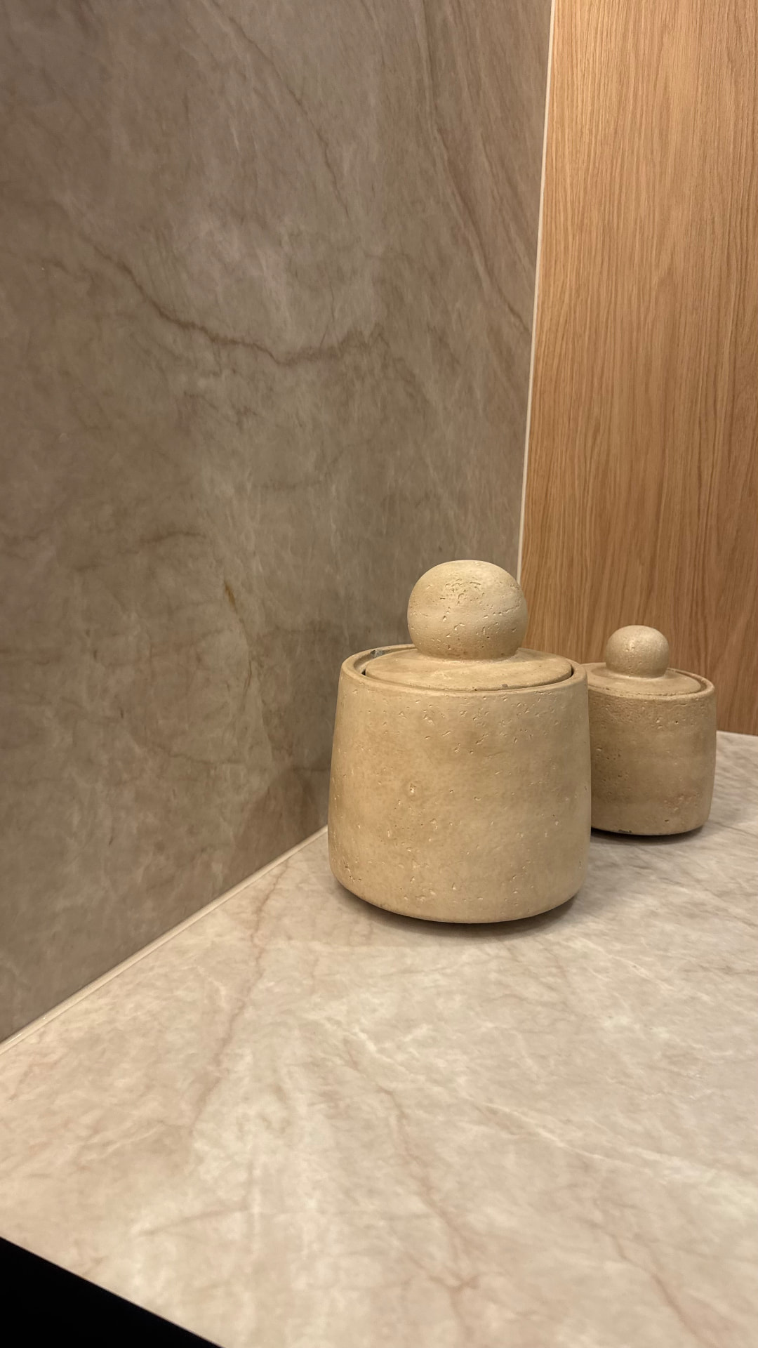 Close-up of a sealed corner joint between stone splashback and benchtop