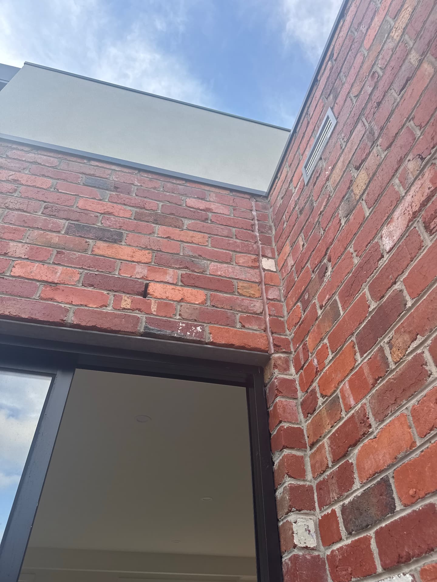 External brickwork corner expansion joint sealed above a window
