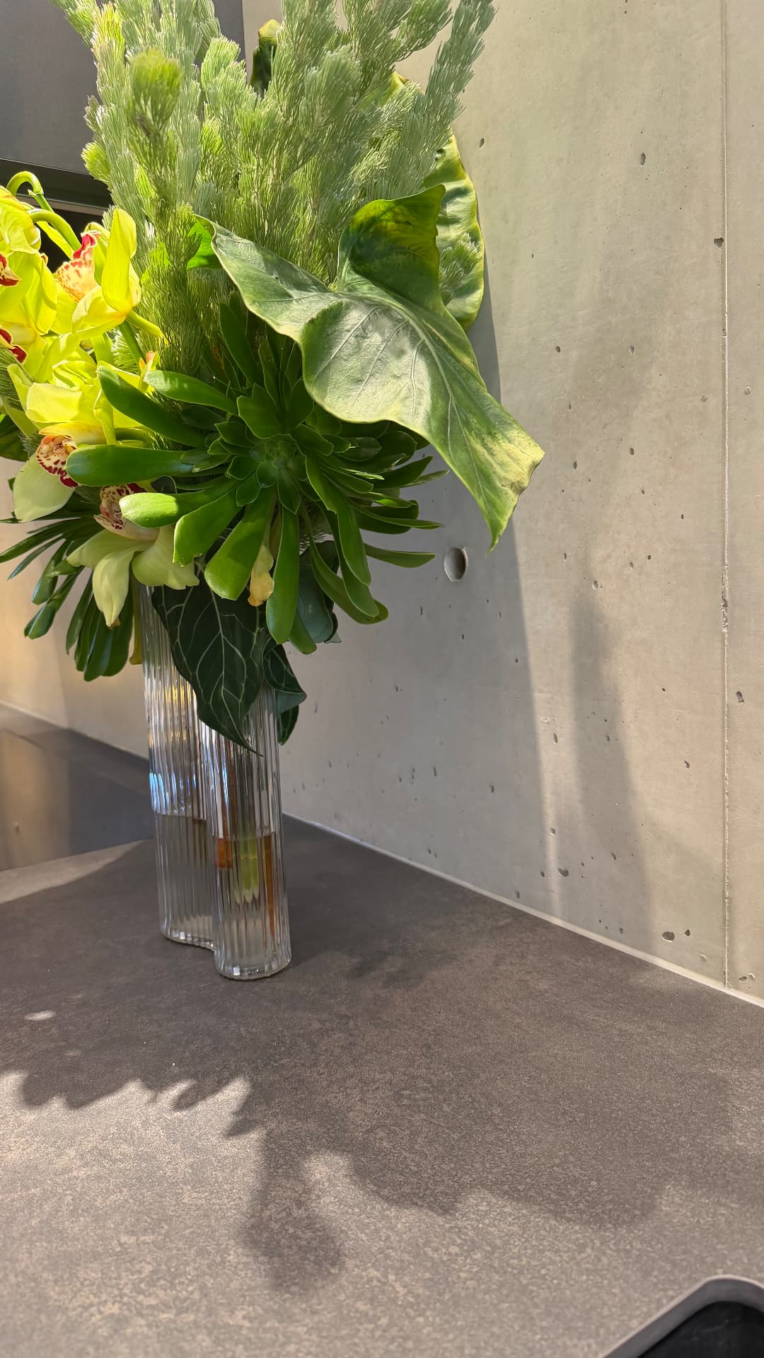 Close-up of sealed junction between benchtop and concrete wall panel