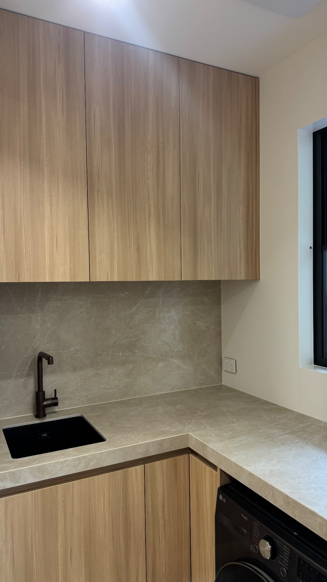 Laundry with sealed sink, stone benchtop and splashback joints