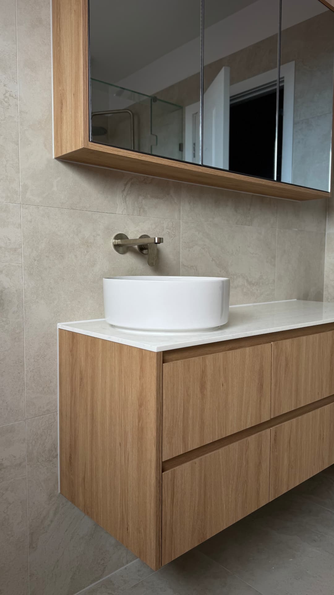 Timber vanity with sealed stone benchtop and round basin