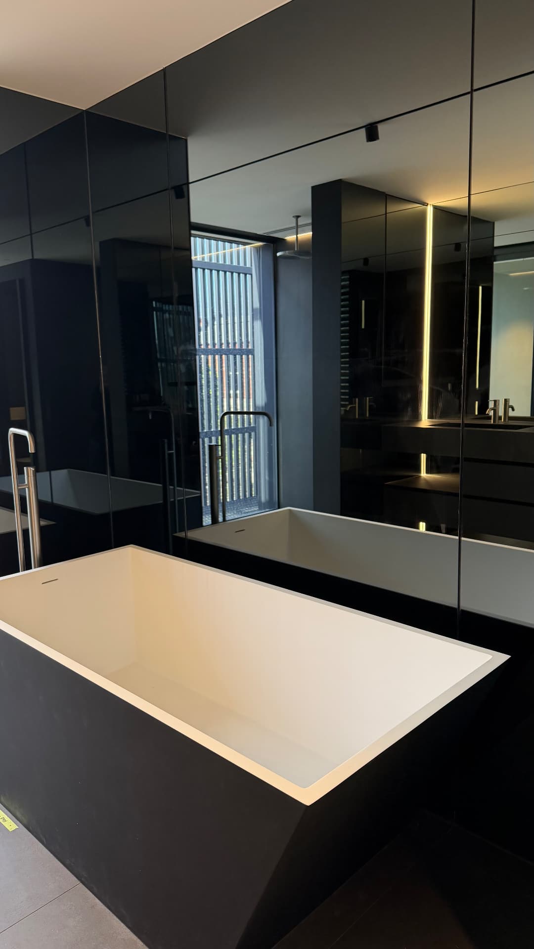 Freestanding bath with sealed black stone surround