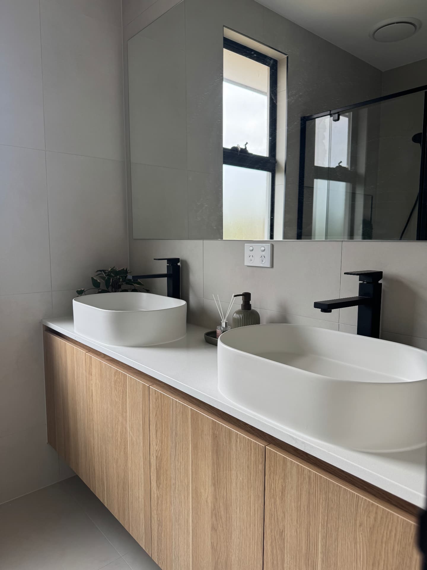 Double vanity with vessel basins and sealed stone benchtop